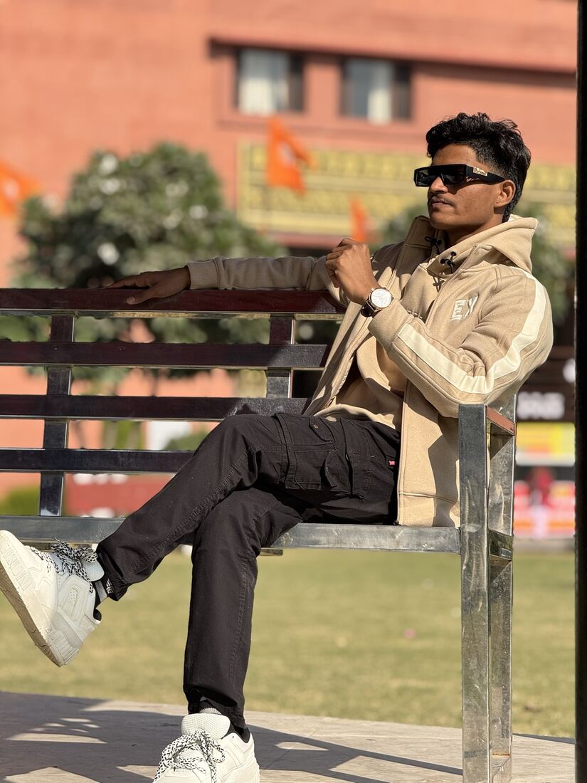 In sunglasses and a jacket on a bench